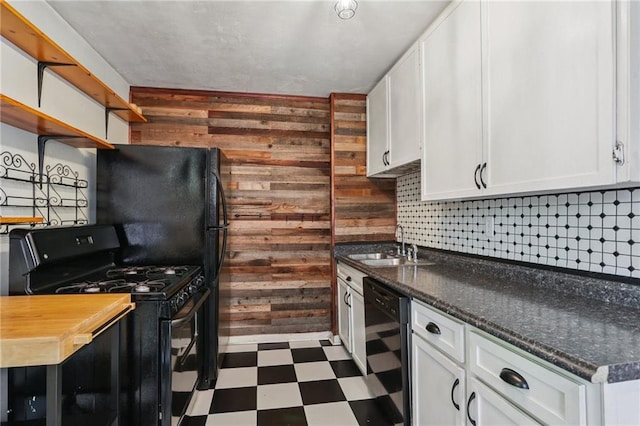 820-22 N Salcedo St, New Orleans, LA 70119 - kitchen with black range with gas cooktop, wine cooler, tile patterned floors, wood walls, and white cabinetry