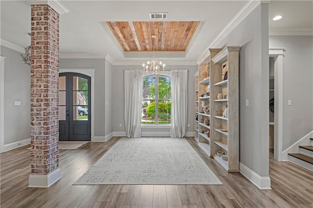 1104 Cypress Crossing Dr, Madisonville, LA 70447 - entryway with healthy amount of natural light, wood finished floors, a chandelier, crown molding, and stairs