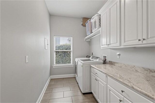 1104 Cypress Crossing Dr, Madisonville, LA 70447 - laundry room featuring washing machine and clothes dryer, cabinet space, and light tile patterned floors