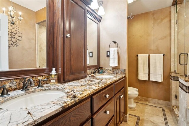 925 Winona Dr, Mandeville, LA 70471 - full bathroom featuring double vanity, a stall shower, and inlaid floor details