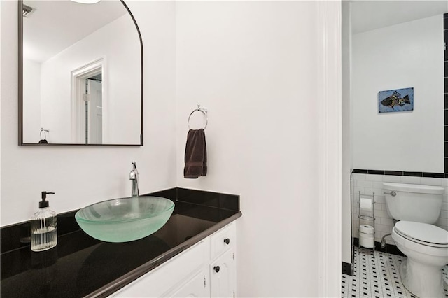 925 Winona Dr, Mandeville, LA 70471 - bathroom featuring vanity, tile patterned flooring, tile walls, and wainscoting