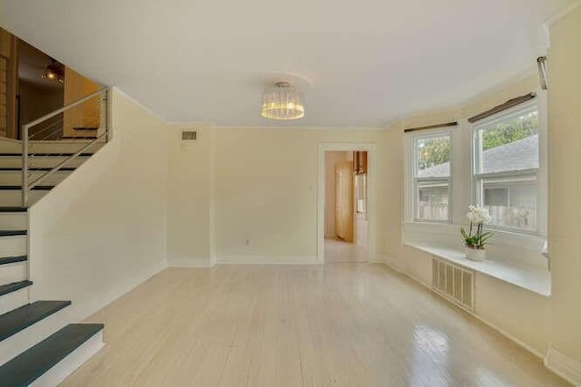 419 W William David Pkwy, Metairie, LA 70005 - unfurnished living room with wood finished floors, stairway, and a chandelier