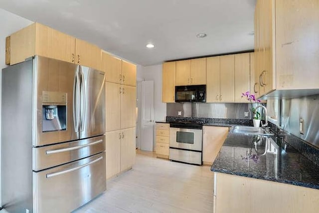 419 W William David Pkwy, Metairie, LA 70005 - kitchen with appliances with stainless steel finishes, light brown cabinets, dark stone countertops, light wood finished floors, and backsplash