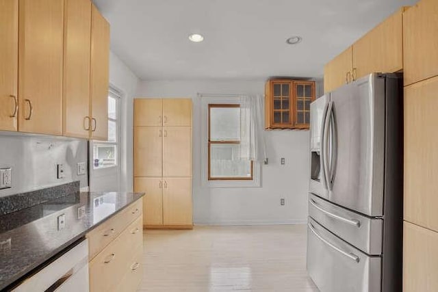 419 W William David Pkwy, Metairie, LA 70005 - kitchen featuring stainless steel refrigerator with ice dispenser, dark stone countertops, light brown cabinetry, recessed lighting, and glass insert cabinets