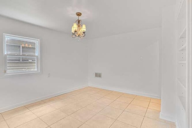 419 W William David Pkwy, Metairie, LA 70005 - empty room featuring a chandelier and light tile patterned flooring