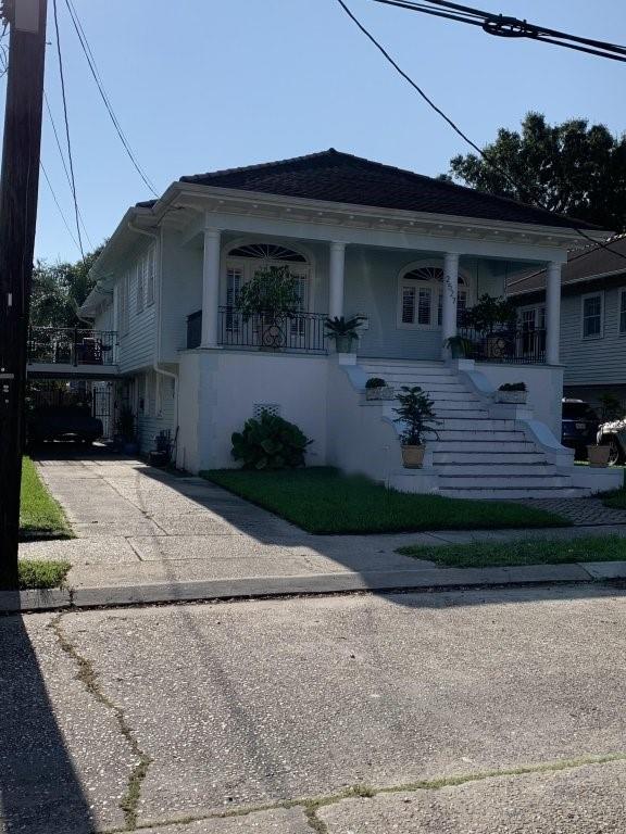 2527 Calhoun St, New Orleans, LA 70118 - view of front of property with stairway, covered porch, and driveway