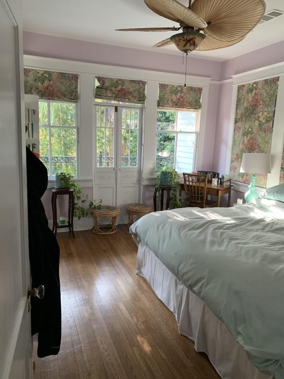 2527 Calhoun St, New Orleans, LA 70118 - bedroom featuring multiple windows, wood finished floors, and a ceiling fan