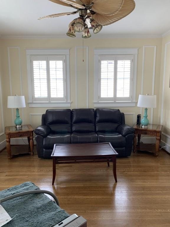 2527 Calhoun St, New Orleans, LA 70118 - living room with healthy amount of natural light, a ceiling fan, crown molding, and wood finished floors