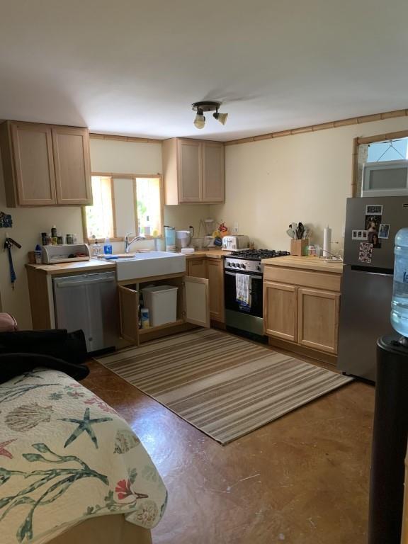 2527 Calhoun St, New Orleans, LA 70118 - kitchen featuring stainless steel appliances, light countertops, and light brown cabinetry