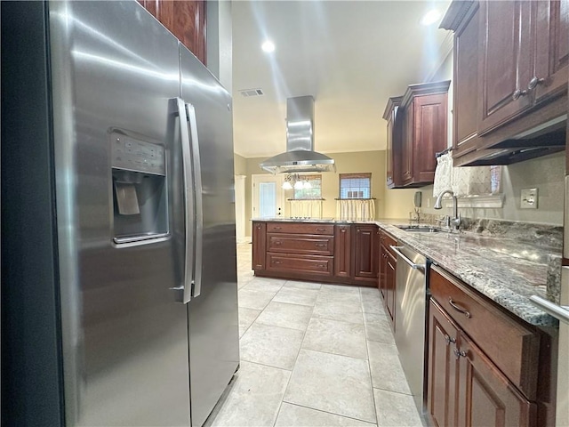 118 Golden Pheasant Dr, Slidell, LA 70461 - kitchen with appliances with stainless steel finishes, wall chimney exhaust hood, a peninsula, light tile patterned floors, and light stone counters