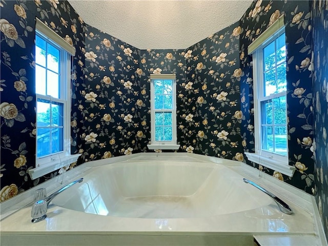 118 Golden Pheasant Dr, Slidell, LA 70461 - full bath with wallpapered walls, a garden tub, and a textured ceiling
