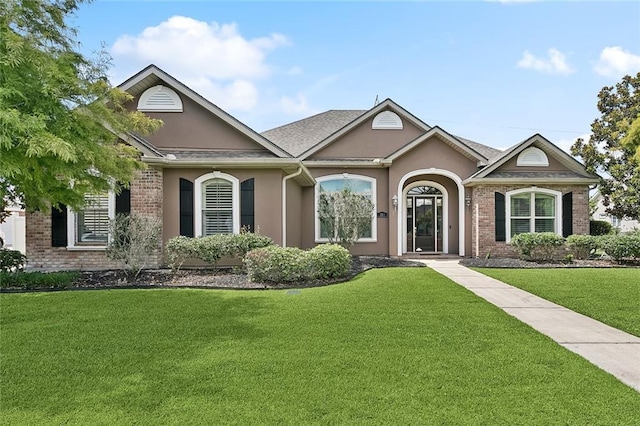 110 Lac Felicity Dr, Luling, LA 70070 - ranch-style house with a front yard, stucco siding, and brick siding