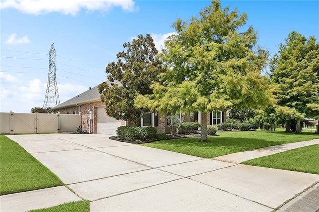 110 Lac Felicity Dr, Luling, LA 70070 - obstructed view of property with a gate, concrete driveway, a garage, and brick siding