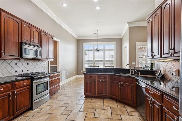 110 Lac Felicity Dr, Luling, LA 70070 - kitchen with stainless steel appliances, stone tile floors, a peninsula, decorative backsplash, and ornamental molding