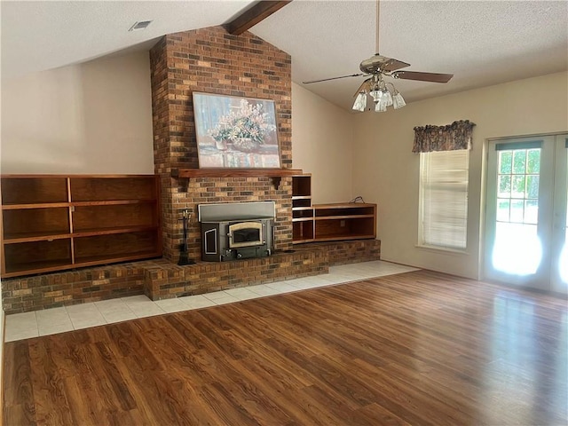 45156 Jenkins Rd 2 Rd, Franklinton, LA 70438 - unfurnished living room with wood finished floors, a ceiling fan, a textured ceiling, and a wood stove