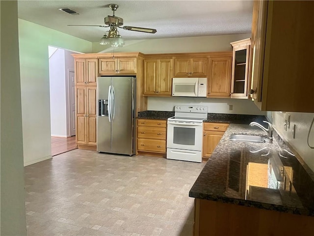 45156 Jenkins Rd 2 Rd, Franklinton, LA 70438 - kitchen with white appliances, ceiling fan, dark stone counters, and glass insert cabinets