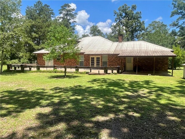 45156 Jenkins Rd 2 Rd, Franklinton, LA 70438 - back of property featuring a lawn, brick siding, and a chimney