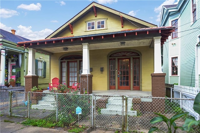 21921 Vallette St, New Orleans, LA 70114 - view of front of home featuring covered porch, a gate, and a fenced front yard