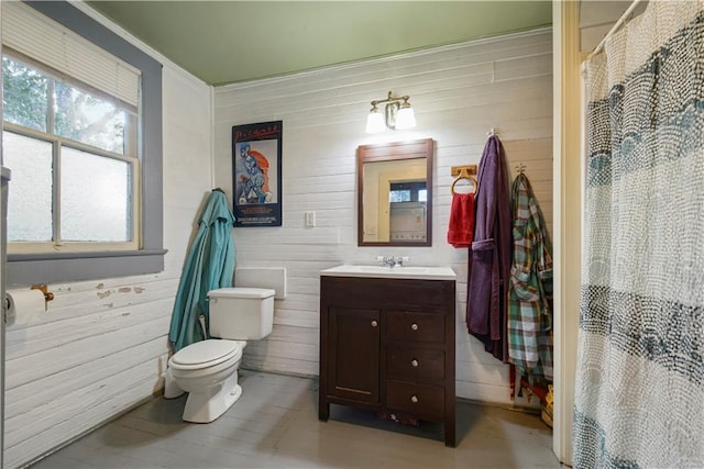 21921 Vallette St, New Orleans, LA 70114 - bathroom with vanity, wooden walls, and a shower with curtain