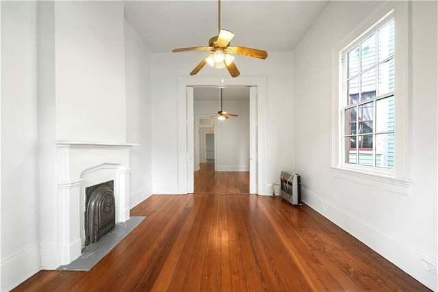 21921 Vallette St, New Orleans, LA 70114 - unfurnished living room featuring a ceiling fan, hardwood / wood-style flooring, a fireplace, and heating unit