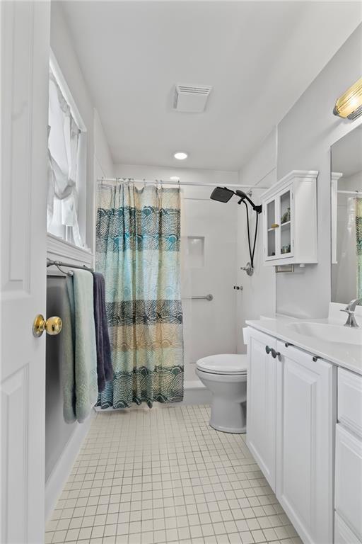 4301 Napoli Dr, Metairie, LA 70002 - full bathroom featuring vanity, tile patterned floors, and a shower with curtain