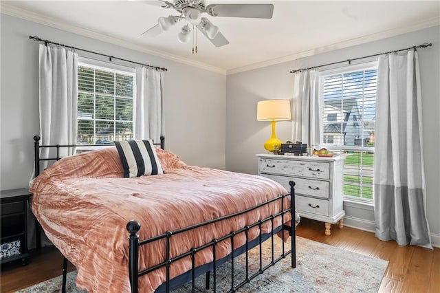 4301 Napoli Dr, Metairie, LA 70002 - bedroom featuring multiple windows, wood finished floors, crown molding, and a ceiling fan