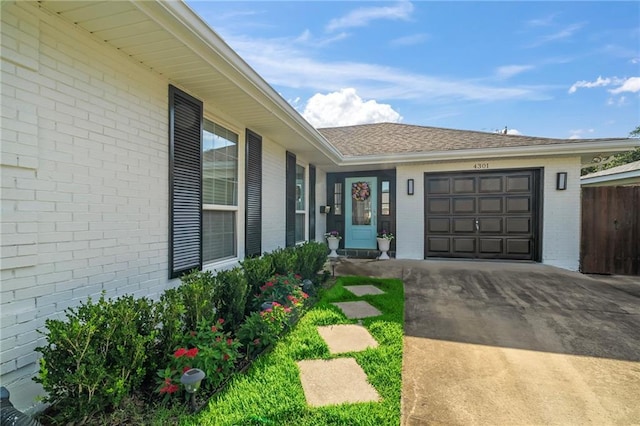 4301 Napoli Dr, Metairie, LA 70002 - view of front of house featuring a garage, brick siding, driveway, and a shingled roof
