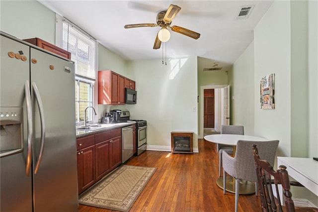 751618 Willow St, New Orleans, LA 70118 - kitchen with stainless steel appliances, a ceiling fan, dark brown cabinets, and dark wood-style flooring