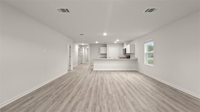 4674 Marais River Dr, Slidell, LA 70461 - unfurnished living room featuring light wood-type flooring and recessed lighting