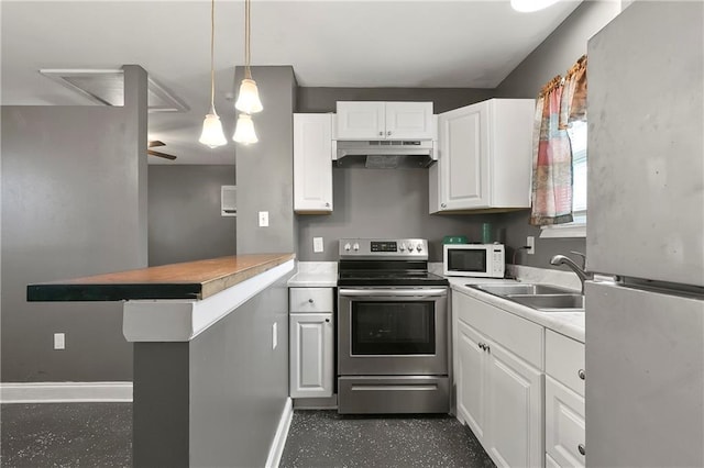 3309 Oak Dr, Violet, LA 70092 - kitchen with freestanding refrigerator, stainless steel electric range, under cabinet range hood, white microwave, and white cabinets