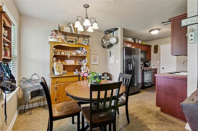 17126 Beacon St, Ponchatoula, LA 70454 - dining room with healthy amount of natural light, a chandelier, and light tile patterned floors