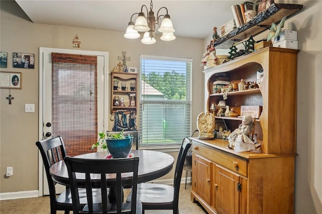 17126 Beacon St, Ponchatoula, LA 70454 - dining area featuring a chandelier and baseboards