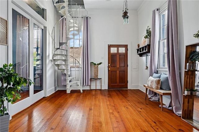 332 Olivier St, New Orleans, LA 70114 - foyer entrance featuring plenty of natural light, wood-type flooring, a towering ceiling, and ornamental molding