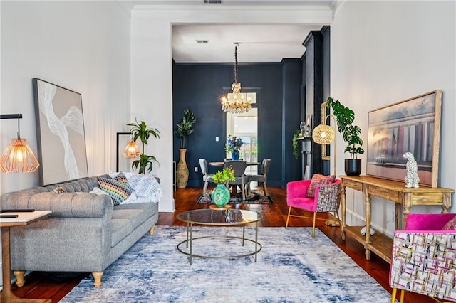 332 Olivier St, New Orleans, LA 70114 - living area featuring a chandelier, wood finished floors, and ornamental molding