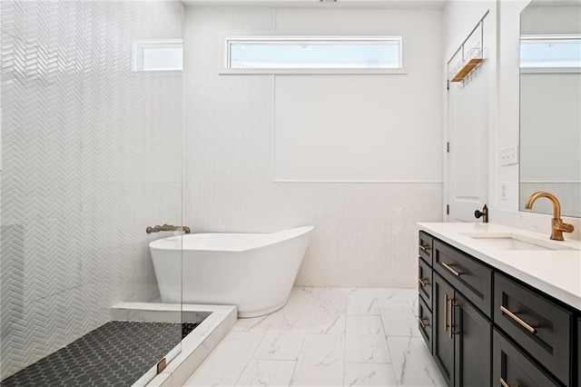 332 Olivier St, New Orleans, LA 70114 - bathroom featuring marble finish floors, vanity, a freestanding bath, and a wainscoted wall