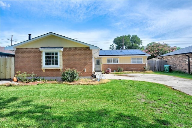 210 Incarnate Word Dr, Kenner, LA 70065 - view of front facade featuring brick siding, roof mounted solar panels, and driveway