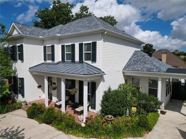 242 Douglas Dr, New Orleans, LA 70123 - view of front of property featuring a standing seam roof, a shingled roof, and a metal roof