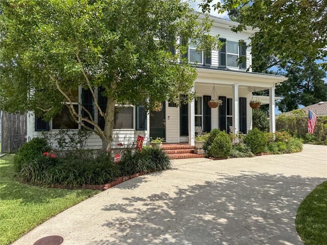 242 Douglas Dr, New Orleans, LA 70123 - view of front of house with covered porch
