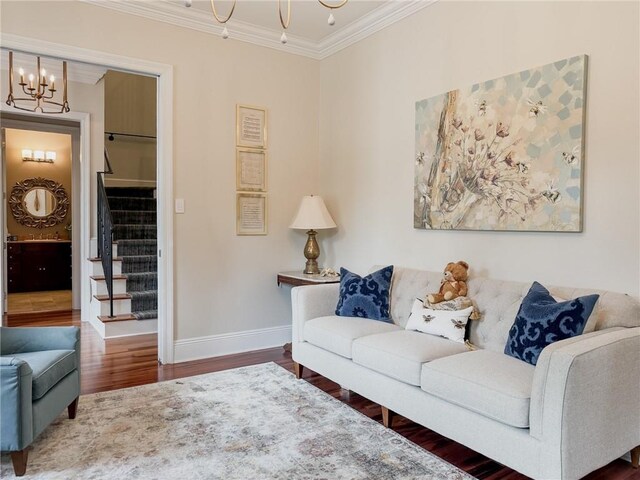 242 Douglas Dr, New Orleans, LA 70123 - living room featuring crown molding, wood finished floors, stairs, and a chandelier