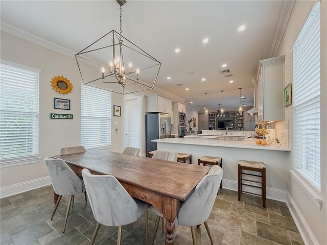242 Douglas Dr, New Orleans, LA 70123 - dining room featuring stone finish flooring, a chandelier, crown molding, and recessed lighting