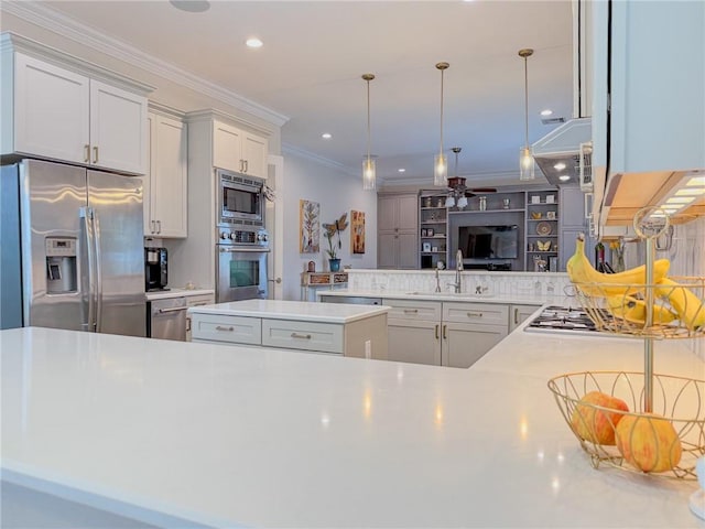 242 Douglas Dr, New Orleans, LA 70123 - kitchen featuring stainless steel appliances, a ceiling fan, light countertops, crown molding, and decorative light fixtures