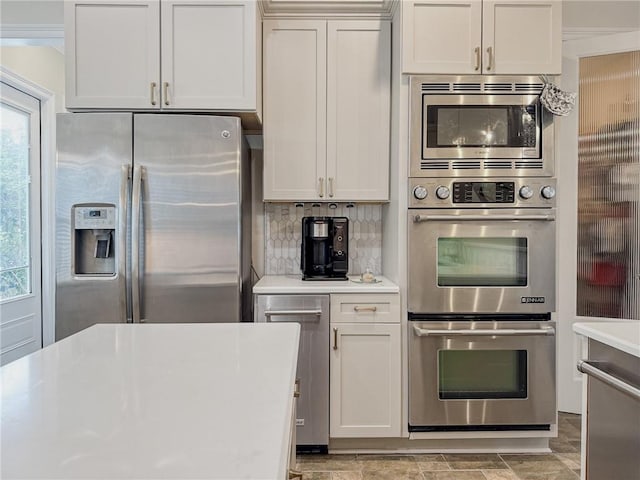 242 Douglas Dr, New Orleans, LA 70123 - kitchen with appliances with stainless steel finishes, light countertops, and backsplash