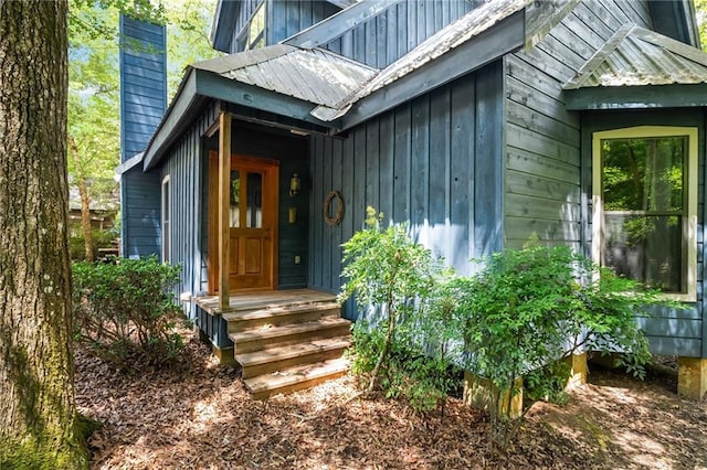 81011 Bob Baxter Rd, Bush, LA 70431 - view of exterior entry with a chimney and board and batten siding