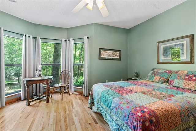 81011 Bob Baxter Rd, Bush, LA 70431 - bedroom with wood finished floors, a textured ceiling, and ceiling fan