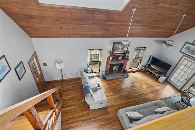 81011 Bob Baxter Rd, Bush, LA 70431 - living room featuring vaulted ceiling, wood ceiling, a glass covered fireplace, wood finished floors, and healthy amount of natural light