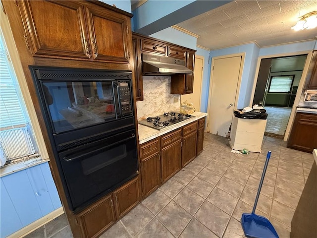 652 Central Ave, Reserve, LA 70084 - kitchen with oven, stainless steel gas stovetop, ornamental molding, under cabinet range hood, and tasteful backsplash