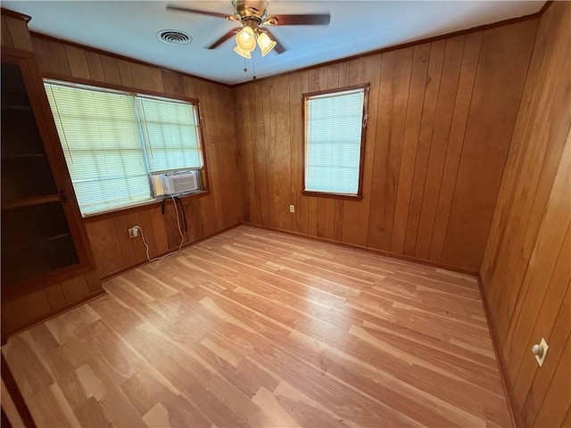 652 Central Ave, Reserve, LA 70084 - unfurnished room featuring healthy amount of natural light, light wood-style floors, ceiling fan, and wood walls