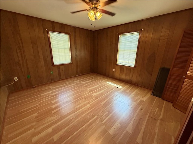 652 Central Ave, Reserve, LA 70084 - spare room with plenty of natural light, light wood-style floors, a ceiling fan, and wooden walls