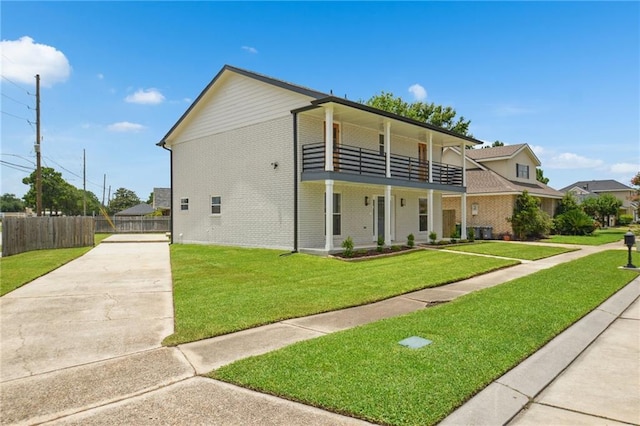 3101 Lake Trail Dr, Metairie, LA 70003 - view of front of home with a balcony, driveway, and brick siding