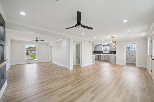 3101 Lake Trail Dr, Metairie, LA 70003 - unfurnished living room featuring ceiling fan, crown molding, healthy amount of natural light, recessed lighting, and light wood finished floors